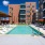 swimming pool in a courtyard with lounge chairs