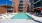 swimming pool in a courtyard with lounge chairs