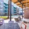 covered patio with seating next to a pool