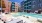 swimming pool in a courtyard with lounge chairs