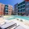 swimming pool in a courtyard with lounge chairs