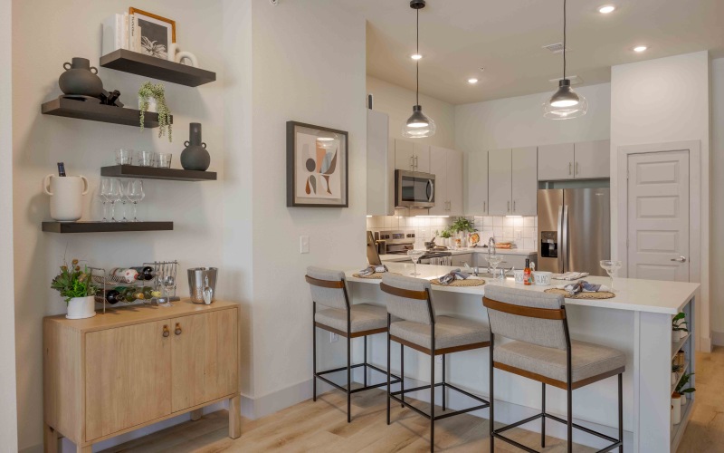 a kitchen with a dining table and chairs