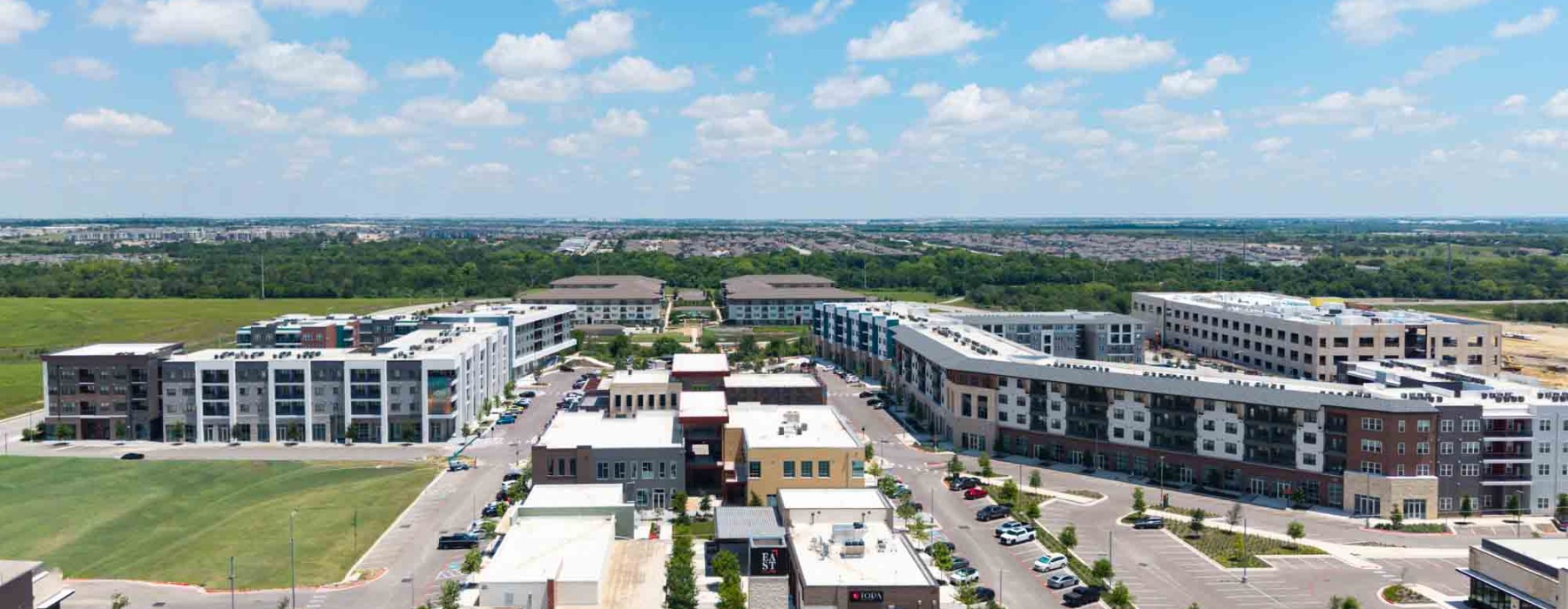 Aerial photo of The Janis apartments near Walnut Creek surrounded by lush greenery.	